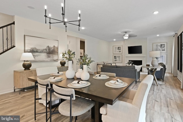 8 Timberidge Dr, Fredericksburg, VA 22406 - dining area with a fireplace, a ceiling fan, light wood-type flooring, a chandelier, and recessed lighting