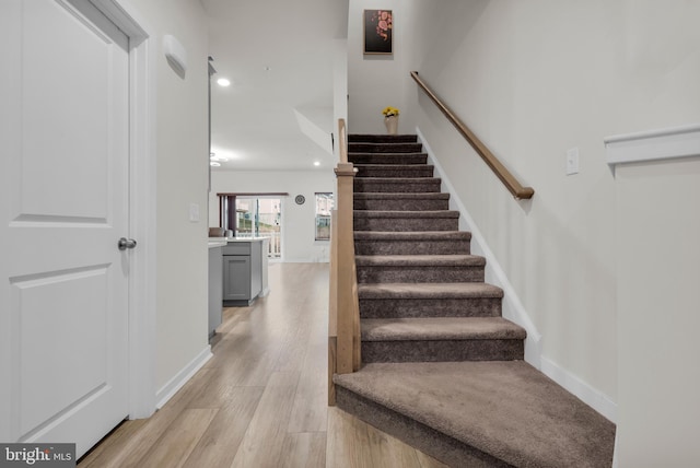 stairs with hardwood / wood-style flooring