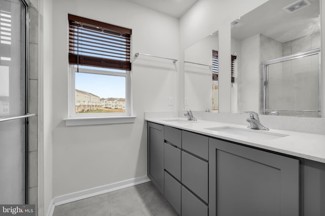 bathroom with vanity and a shower with door