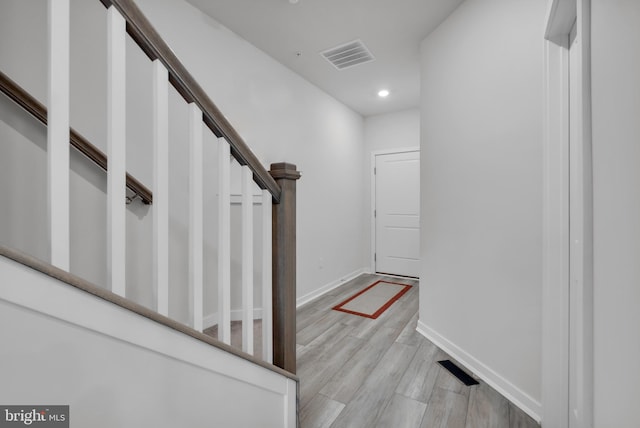 stairway with hardwood / wood-style flooring