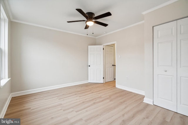 unfurnished bedroom with light wood-type flooring, a closet, ceiling fan, and ornamental molding