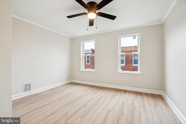 empty room featuring crown molding, ceiling fan, and light hardwood / wood-style floors