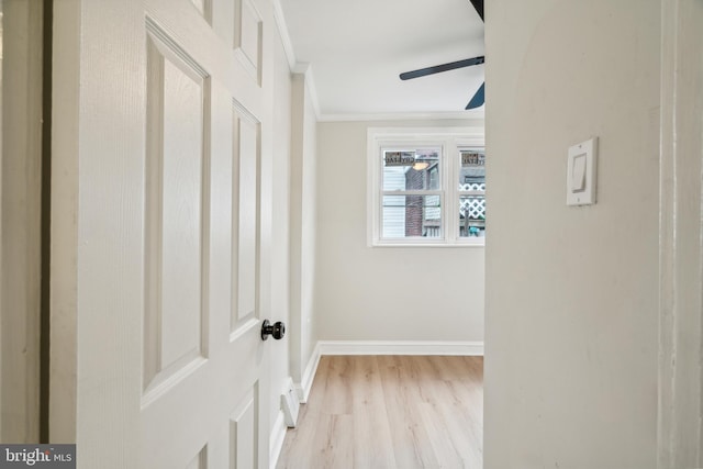 hall featuring ornamental molding and light hardwood / wood-style flooring