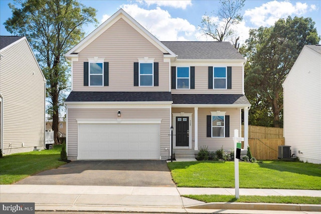 view of front facade with central AC unit, a garage, and a front lawn