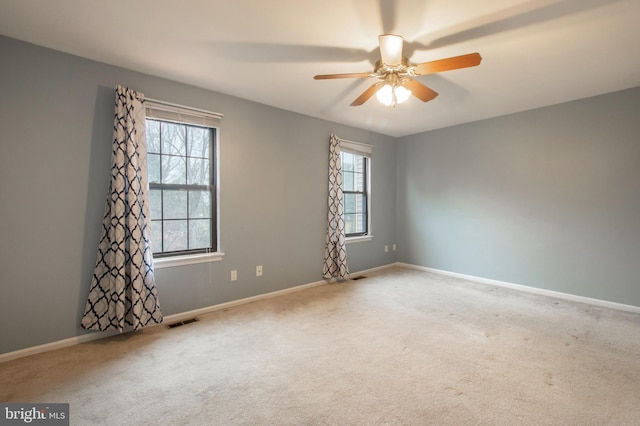 spare room featuring carpet flooring and ceiling fan