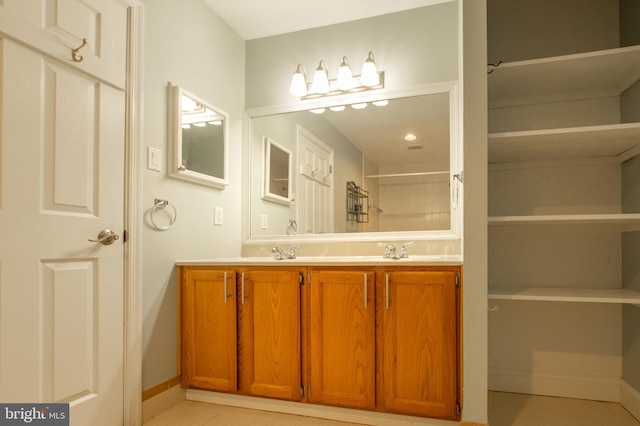 bathroom with tile patterned floors and vanity