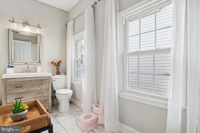 bathroom featuring vanity and toilet