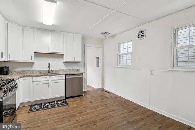 kitchen featuring dark wood-type flooring, white cabinets, stainless steel appliances, and sink