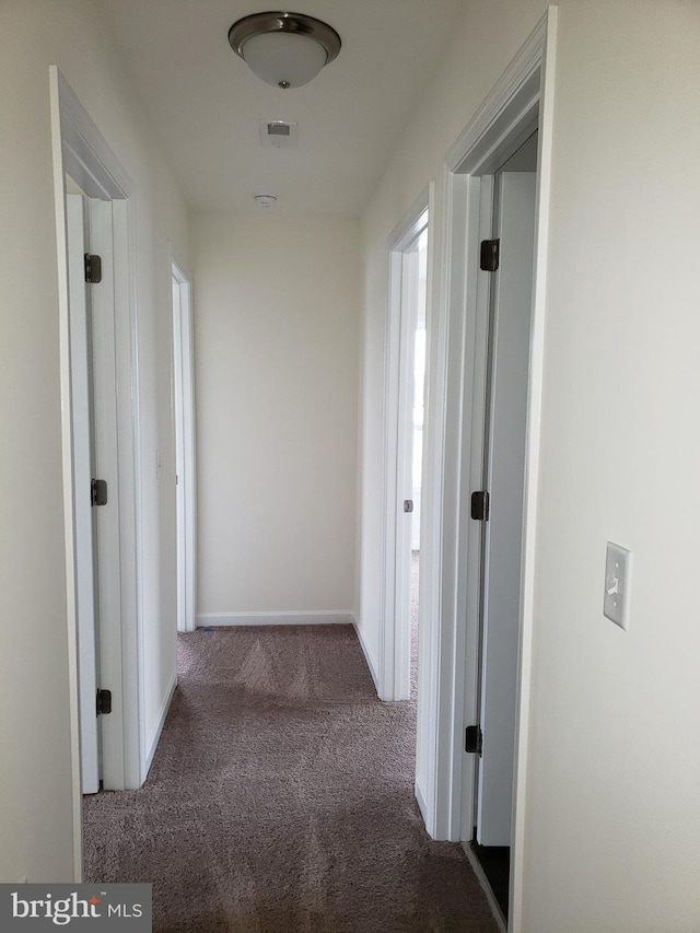 corridor with dark colored carpet