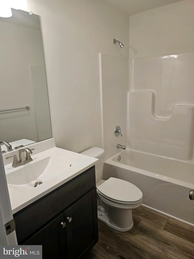 full bathroom with vanity, shower / bathtub combination, toilet, and wood-type flooring