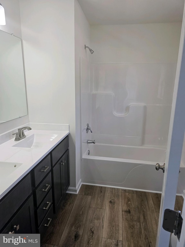 bathroom featuring vanity, shower / bathtub combination, and hardwood / wood-style flooring