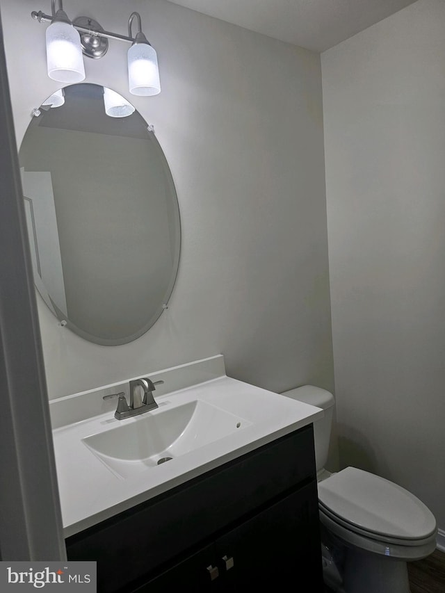 bathroom featuring vanity and toilet