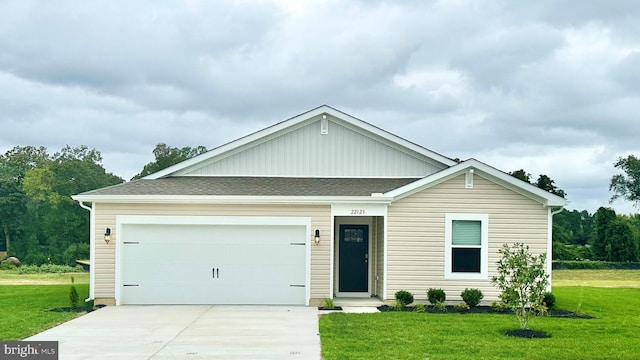 view of front of house with a garage and a front lawn