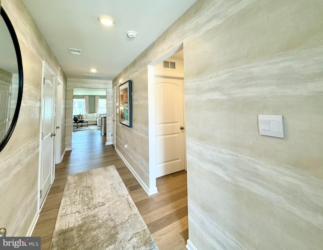 hallway with hardwood / wood-style floors