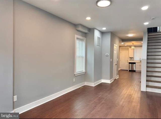 725 N Streeper St, Baltimore, MD 21205 - unfurnished living room featuring dark wood finished floors, stairs, and recessed lighting