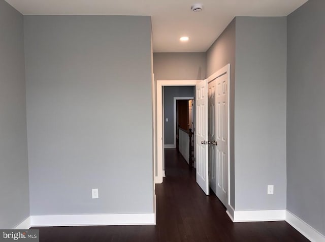 corridor with dark wood-type flooring