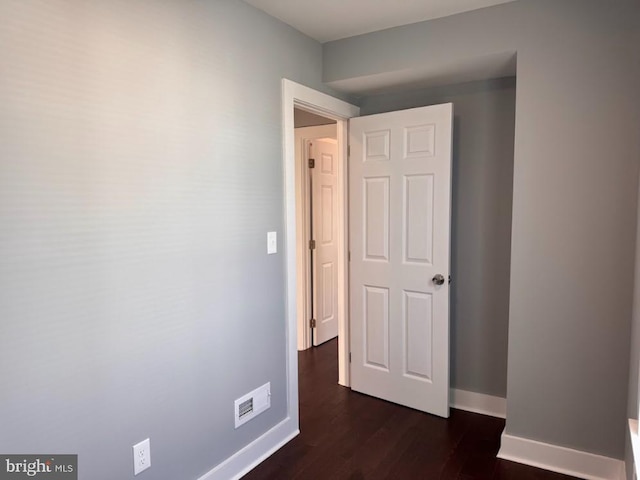 corridor with dark hardwood / wood-style floors