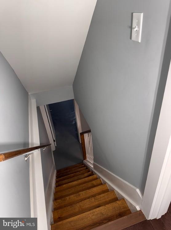 stairway featuring hardwood / wood-style flooring