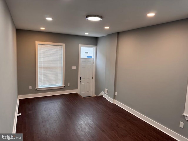 empty room with dark hardwood / wood-style floors