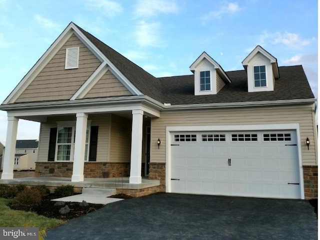 view of front of house with covered porch and a garage