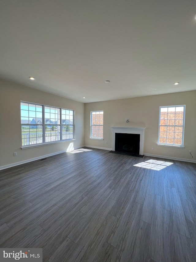 unfurnished living room with dark hardwood / wood-style floors