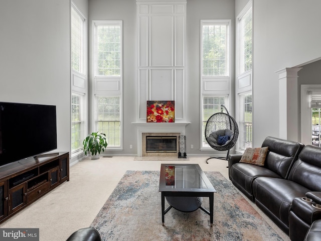 living room with carpet floors, ornate columns, and a wealth of natural light