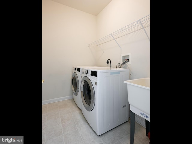 laundry room with sink and washing machine and clothes dryer