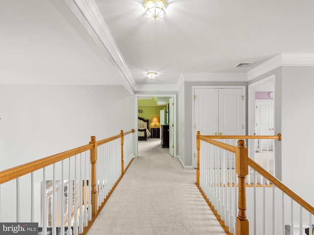 hall featuring ornamental molding and light carpet