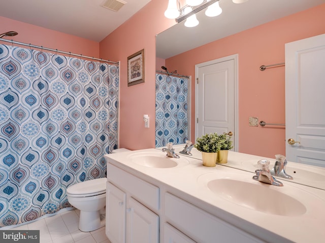 bathroom featuring tile patterned flooring, vanity, and toilet