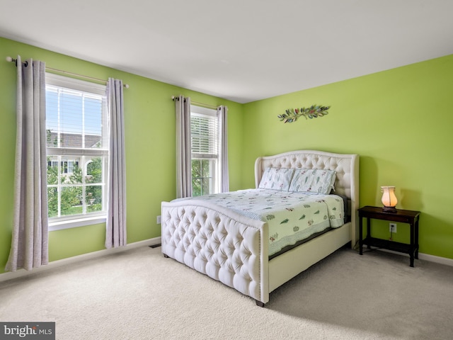 bedroom featuring multiple windows and carpet floors