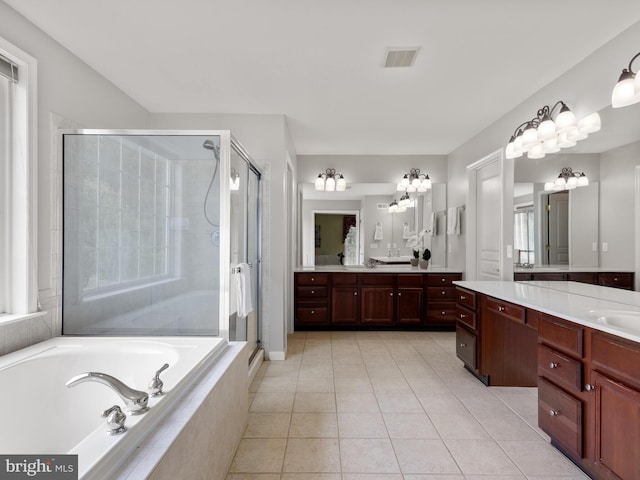 bathroom with tile patterned floors, vanity, plenty of natural light, and plus walk in shower