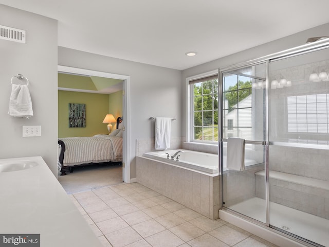 bathroom with shower with separate bathtub, vanity, and tile patterned floors