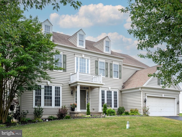 view of front of house with a balcony, a front lawn, and a garage