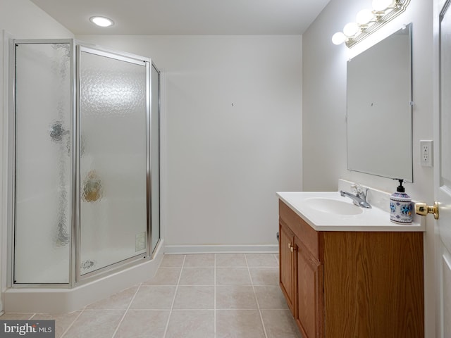 bathroom with tile patterned floors, vanity, and a shower with door