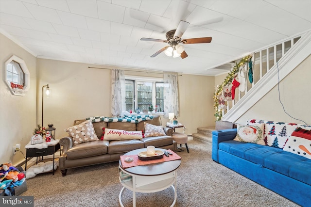 living room featuring ceiling fan, crown molding, and carpet