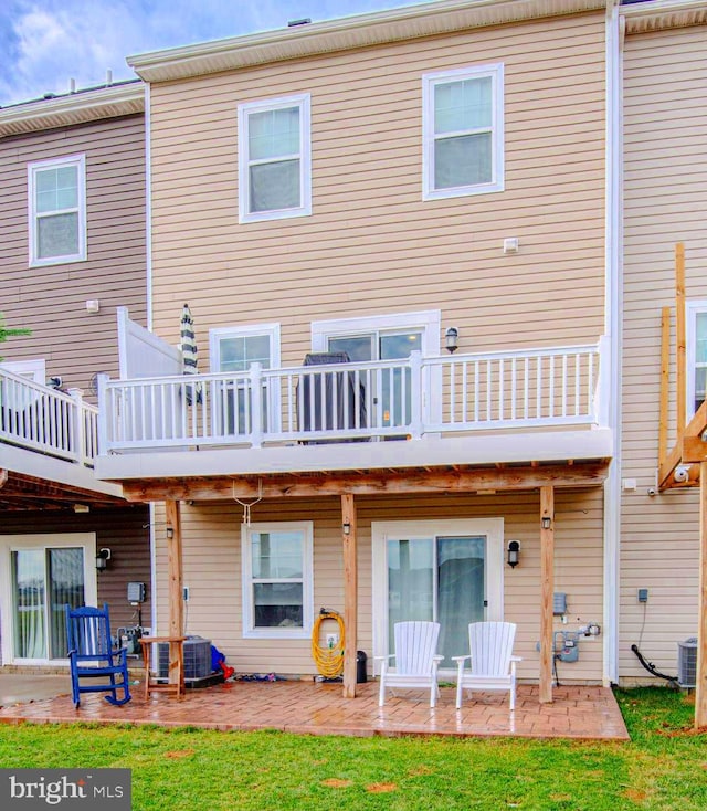 back of house with a patio