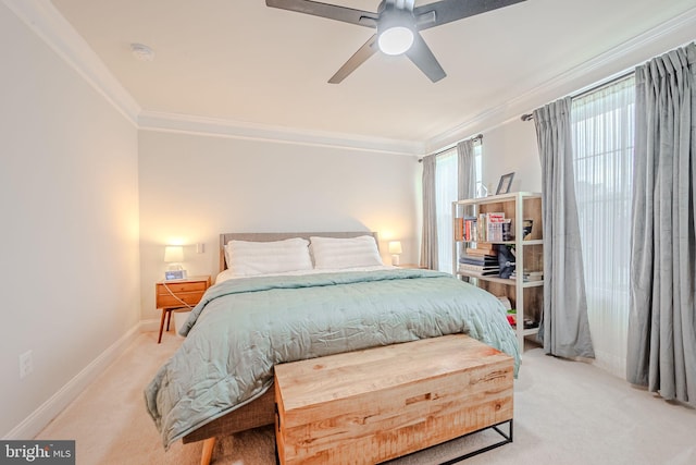 carpeted bedroom featuring ceiling fan and ornamental molding