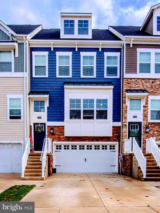 view of property with driveway and a garage