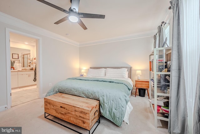 carpeted bedroom featuring ceiling fan, ensuite bathroom, and ornamental molding