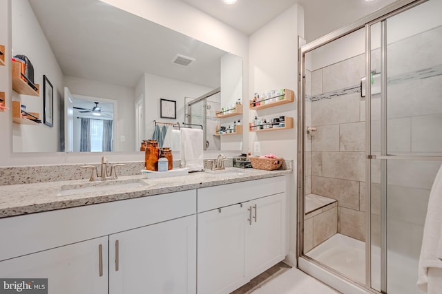 bathroom featuring vanity, walk in shower, and ceiling fan