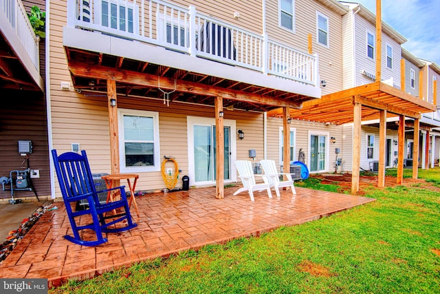 rear view of property featuring a patio area and a yard