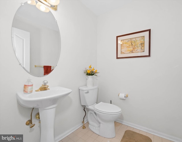 bathroom with toilet and tile patterned flooring