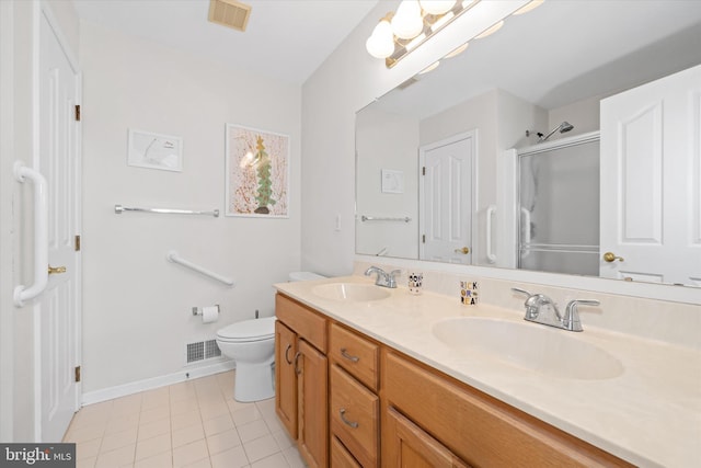 bathroom with toilet, a shower with door, tile patterned floors, and vanity