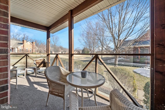 unfurnished sunroom featuring beam ceiling