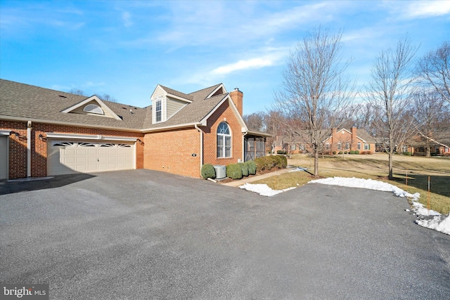 view of property exterior with central AC and a garage