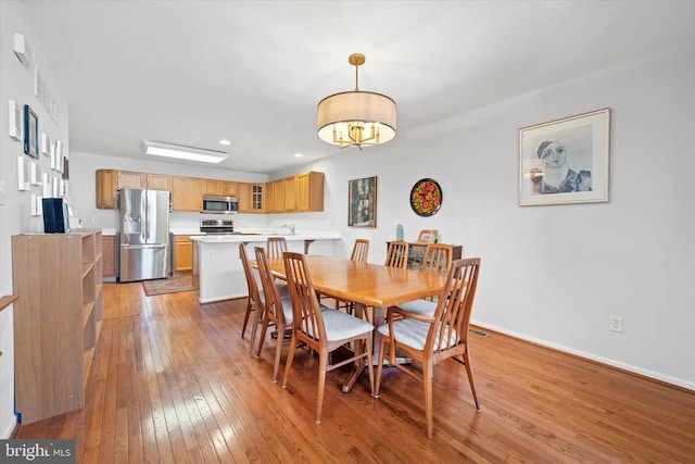 dining space with light wood-type flooring