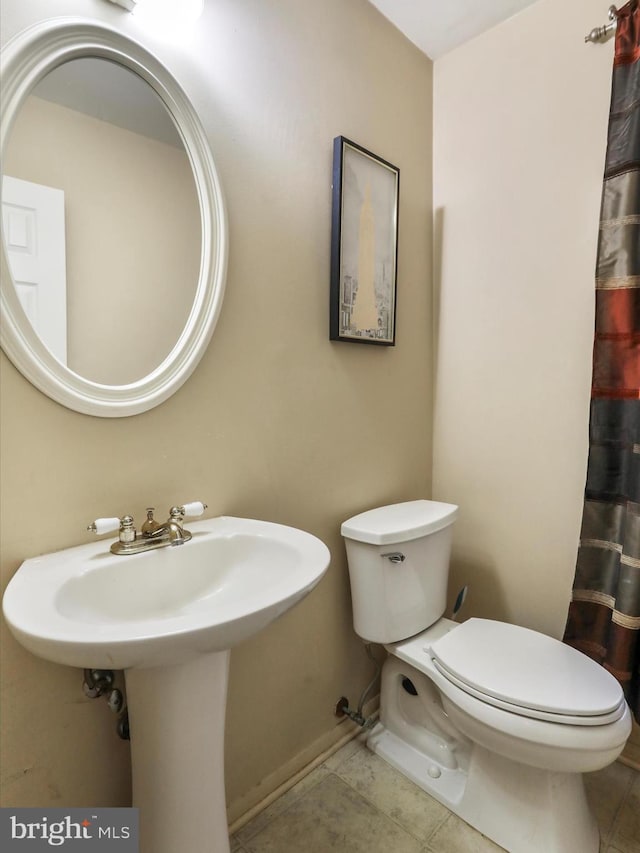 bathroom with tile patterned floors and toilet