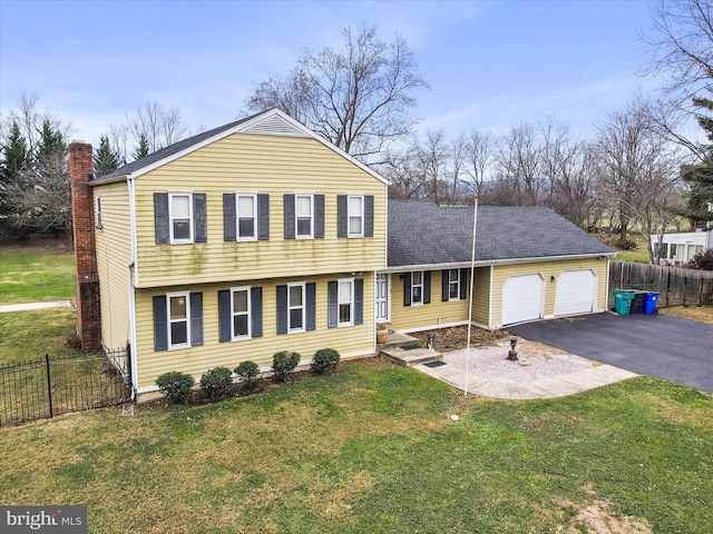 view of front of property with a garage and a front lawn