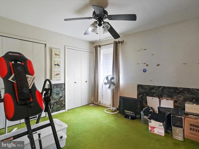 interior space with carpet flooring and ceiling fan