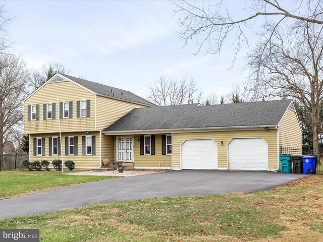 view of front facade with a front yard and a garage